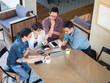 © Viewvie - Happy time of group of people meet in coffee shop, hang out and use technology of laptop, smartphone and computer laptop.