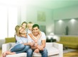 © BillionPhotos.com - Beautiful smiling family sitting at sofa at home