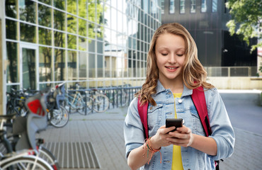 Wall Mural - education and people concept - happy smiling teenage student girl with bag and smartphone over school yard background