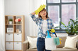 © Syda Productions - people, housework and housekeeping concept - tired asian woman holding bucket full of cleaning stuff at home