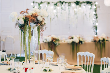 Wall Mural - Gorgeous luxury wedding table arrangement, floral centerpiece close up. The table is served with cutlery, crockery and covered with a tablecloth. Wedding party decoration with pink and white flowers.