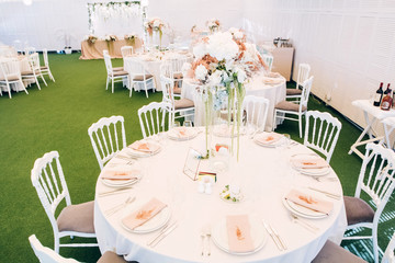 Wall Mural - Gorgeous luxury wedding table arrangement, floral centerpiece close up. The table is served with cutlery, crockery and covered with a tablecloth. Wedding party decoration with pink and white flowers.