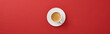 top view of white cup with fresh coffee on saucer on red background, panoramic shot