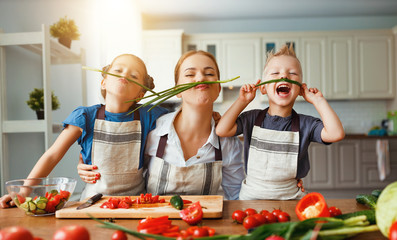Wall Mural - mother with children preparing vegetable salad