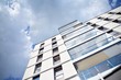 © Grand Warszawski - Modern apartment buildings on a sunny day with a blue sky. Facade of a modern apartment building
