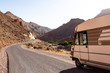 A camping car, van on the road with the mountains