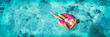 Leinwandbild Motiv Beach vacation woman relaxing in pool float donut inflatable ring floating on turquoise ocean water background in Caribbean travel summer banner panorama. Girl in white bikini top drone view.