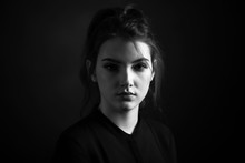 Dramatic Black And White Portrait Of A Beautiful Girl On A Dark Background