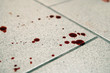 © diy13 - Conceptual image with blood on it resting on tiles on floor