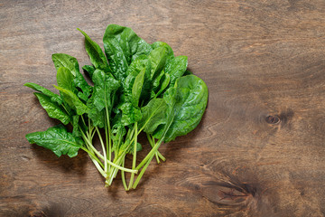 Sticker - Spinach leaves on a wooden table.