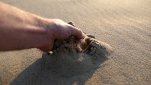 Adult Male Hand Takes Sand From Beach Close Up Slow Motion
