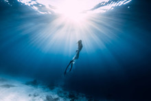 Woman Freediver Glides Over Sandy Sea With Fins