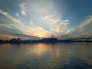 Wall Mural - the sky with the sun will rise in the river