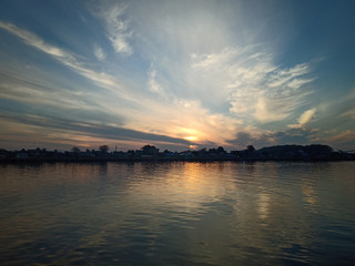 Wall Mural - the sky with the sun will rise in the river