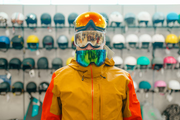 Wall Mural - Man trying on three masks for ski or snowboarding