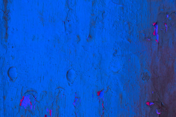 Wall Mural - Background image of close up peeled blue and red color textured wooden building exterior surface