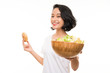 © luismolinero - Asian young woman over isolated background with salad and donut