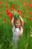 Fototapeta Tulipany - Three year old toddler girl in the summer field of blooming poppy flowers posing with a bouquet
