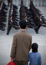 Father And Daughter Watching North Korean Army Parade On Kim Il Sung Square, Pyongan Province, Pyongyang, North Korea