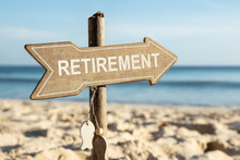 Retirement Directional Sign On Beach