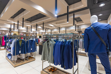 Canvas Print - Internal view of a fashion store with generic jackets, mannequins, jeans and clothes.