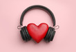 Decorative heart and modern headphones on color background, flat lay