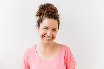 30 years curly woman portrait against white background. Laughter and joy emotions