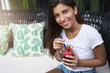 © Liubov Levytska - Alluring young european tanned woman nice flirty smile drinking beverage sit outdoor cafe terrace sofa look up smiling talking boyfriend, have date outside, enjoy smoothie relax weekends
