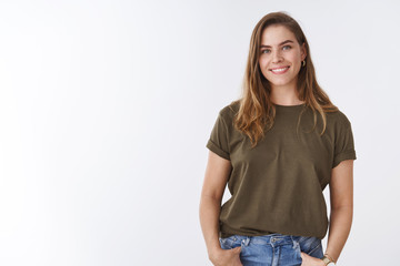 attractive modern young urban woman chestnut short haircut wearing olive t-shirt holding hands pocke