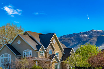 Wall Mural - House exterior against mountain and blue sky viewed on a sunny day