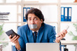 © Elnur - Young male employee with tape on the mouth