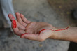 hand with a fresh wound from a cut, red blood flows down the male palm in a jet, close-up