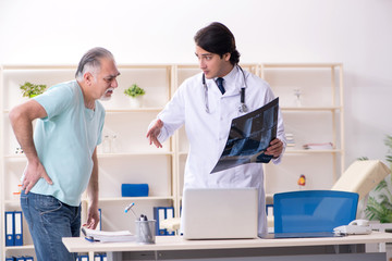 Old man visiting young male doctor 