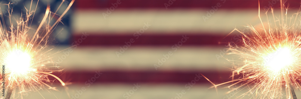 Lit sparkler burning in front of American Flag - obrazy, fototapety, plakaty 