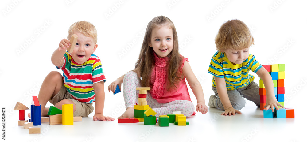 Cute little children playing with toys or blocks and having fun while sitting on floor isolated over white background - obrazy, fototapety, plakaty 