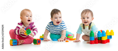 Nursery babies toddlers playing with color toys isolated on white background