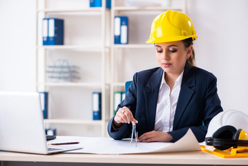 Young female architect working in the office 