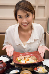 Wall Mural - happy smiling woman eating shabu or sukiyaki, Asian Japanese hot pot food concept