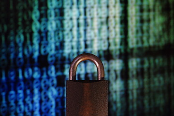 Wall Mural - binary computer language matrix blurred be hide an iron Padlock. sign of computer privacy protection. safety computer and internet environment.