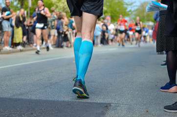 Marathon running race, many runners feet on road racing, sport competition, fitness and healthy lifestyle concept