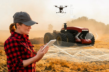 Aufkleber - Woman farmer with digital tablet controls an autonomous tractor and drone on a smart farm	