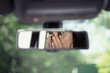 Reflection of young woman with frightened eyes covering her face with  hands in the car rear view mirror. Concept of an accident on the road or knock down pedestrian