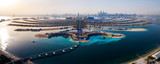 Fototapeta Miasto - The Palm island panorama with Dubai marina in the background aerial