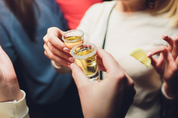 Wall Mural - Hand holding a glass with vodka shot.