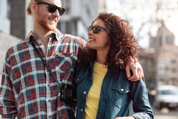 Happy young couple is spending sunny day in city