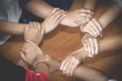 © Tinnakorn - Young team putting hands up for new startup in creative office,  Team Teamwork Togetherness Collaboration Co-working and teamwork concept