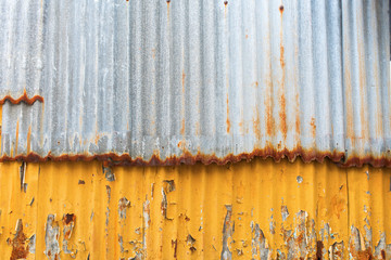 Corrugated rusty colored sheet metal cracked paint