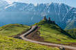 © vladi_mir - Church of the Holy Trinity in the mountains of Georgia, Stepantsminda and Mount Kazbek