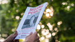 © StockMediaProduction - Man holding a flyer with the announcement of the missing man