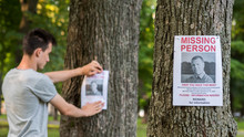 A Young Man Puts Up Ads For A Missing Person In The Park